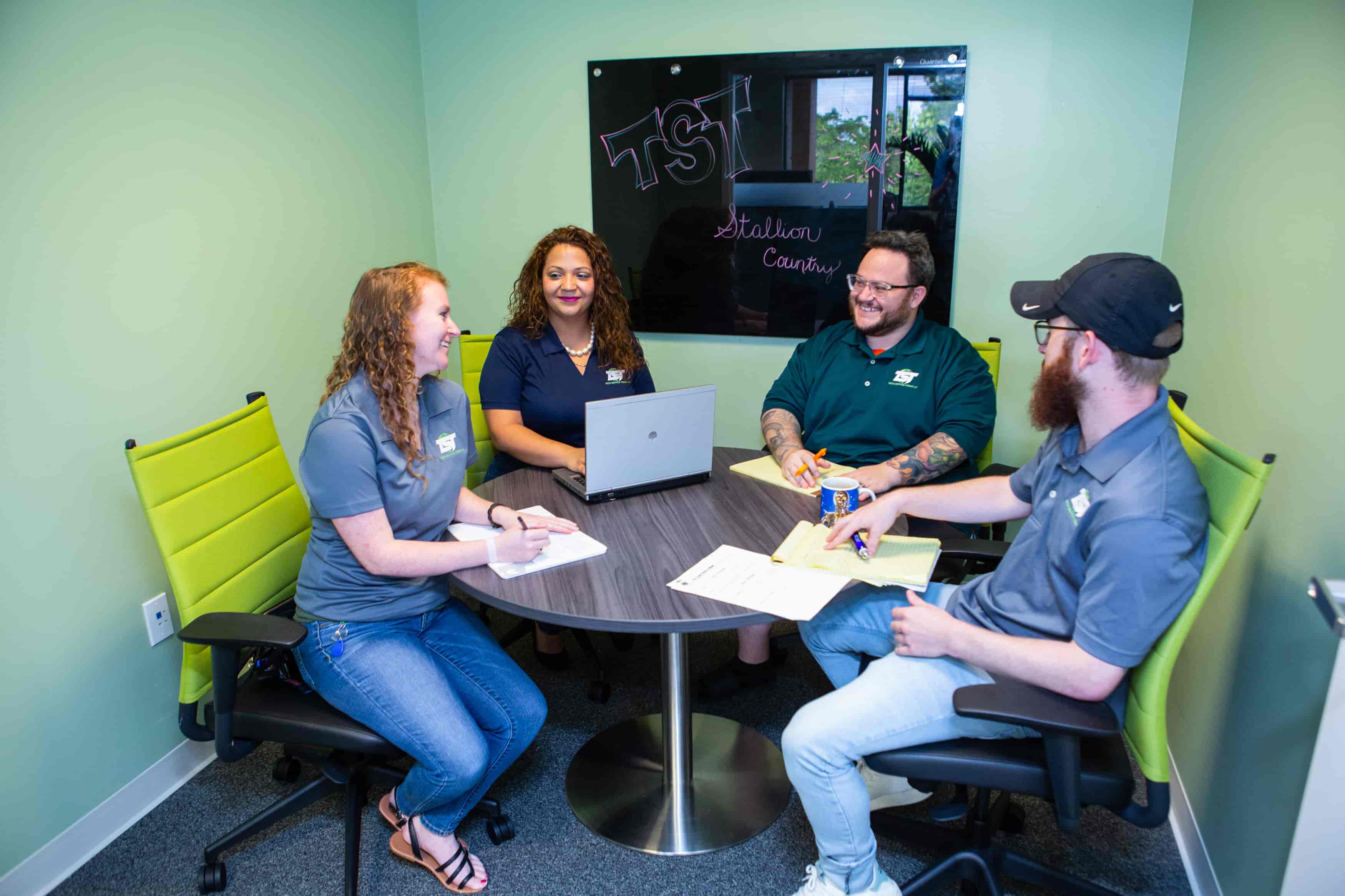 A four person TST office meeting