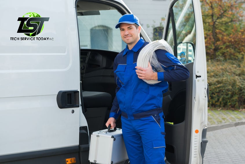 Cabling Technician standing by Van with Cable on arm_50278192_s_w TST Logo on Van