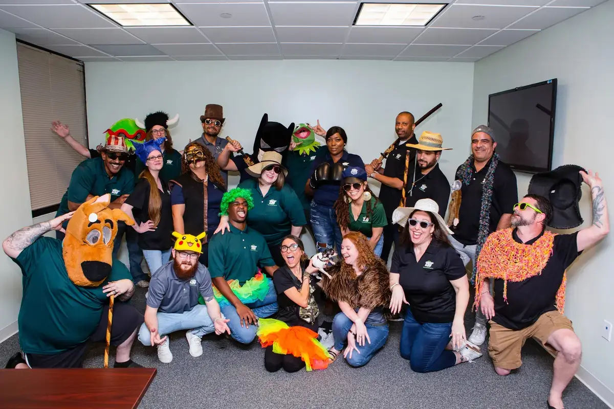 Playful group posing with hats and costumes