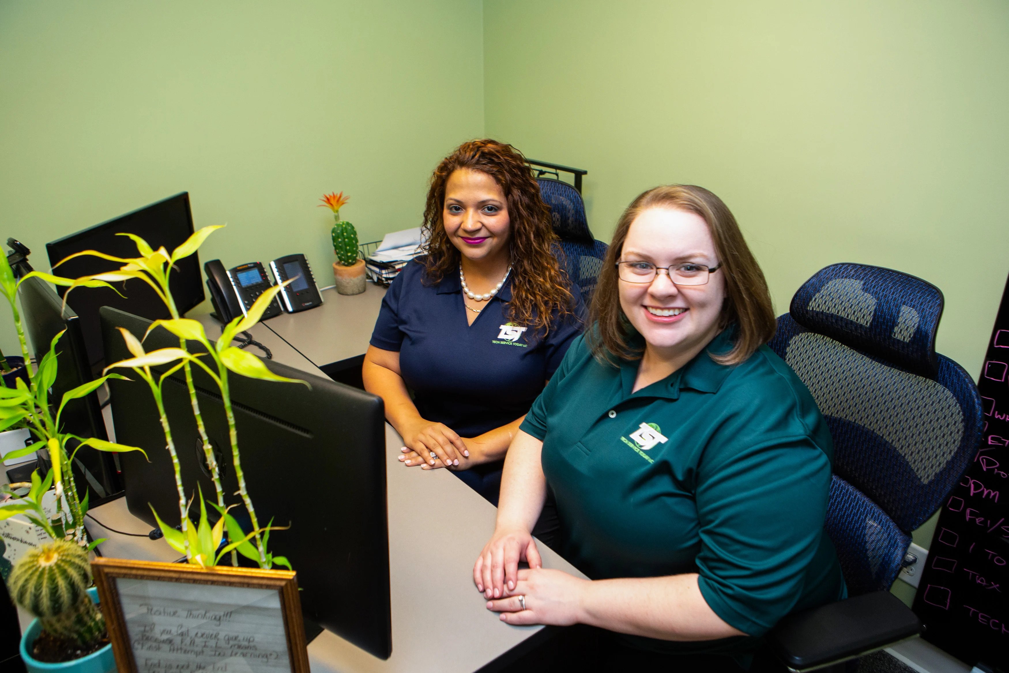 Two TST Emoloyees smiling in an office