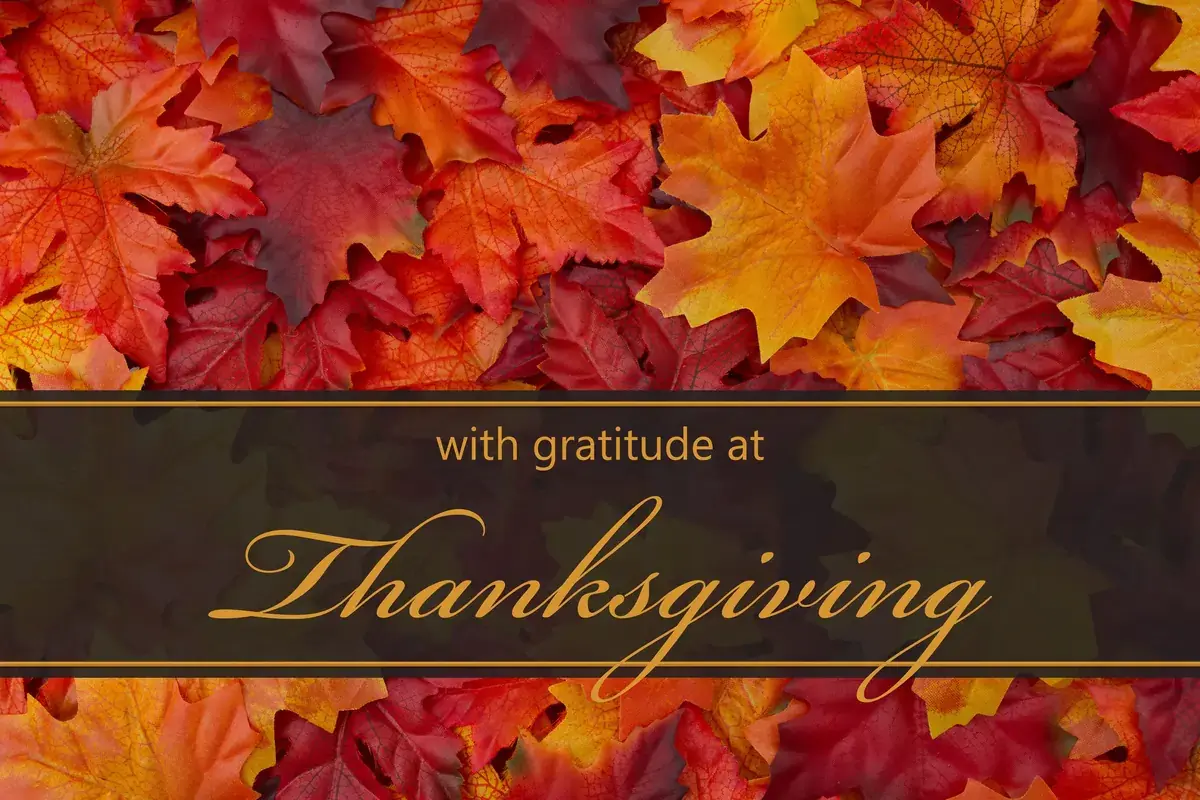 Autumn leaves background with the words “with gratitude at Thanksgiving”