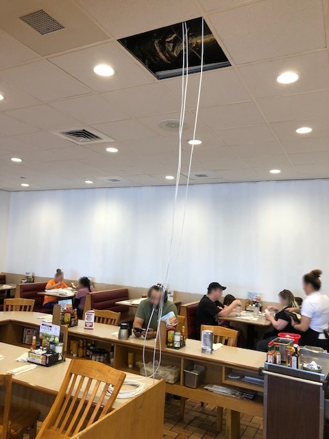 Tech Service Today (TST) IT disaster of network cabling hanging from a restaurant ceiling